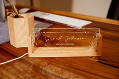 a wooden desk with a business card holder on it