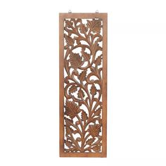 an ornate wooden panel with leaves and flowers on the front, hanging from a hook