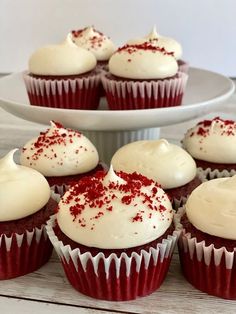 red velvet cupcakes with white frosting and sprinkles on top