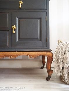 a black cabinet with gold knobs and handles