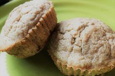 two muffins sitting on top of a green plate