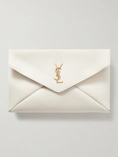 SAINT LAURENT's 'Cassandre' clutch is an instant classic you'll keep coming back to. It's made from leather with a distinct vintage-style grain and detailed with a brushed gold-tone 'YSL' monogram that only adds to its enduring appeal. Stow your phone, keys and even a notebook inside. Designer White Envelope Bag, Designer White Leather Clutch, Saint Laurent Clutch, Wedding Clutch Purse, Ysl Clutch, French Bob, Wedding Purse, Wedding Clutch, Designer Clutch