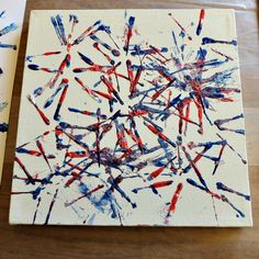 an abstract painting with red, white and blue paint splattered on the canvas