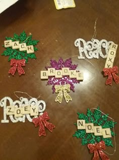 some type of christmas ornament on a table with other ornaments and words that spell out the word noel