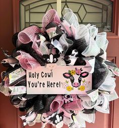 If you love cows, this gorgeous, funny farmhouse style cow wreath was made for you. The handmade sign that says "Holy Cow! You're Here!" will make your guests smile each time they see it. This would be the perfect gift for a dairy farmer or rancher. The base of this wreath is made from black deco mesh. I've layered black, white, and pink ruffles on top and then added four coordinating ribbons. I've also added glittery balls and plastic canvas cows for added interest. This is a year-round, everyday wreath and will look stunning against any door color. The dimensions are approximately 27" wide and 25" long. It is about 6" deep. This is a large, full, fluffy wreath and may not fit between all storm doors. This would also make a great housewarming or birthday gift. All of my wreaths are handma Themed Door Decorations, Door Decorations For Christmas, House Cow, Cow Wreath, Summer Door Decor, Pet Wreath, Gift For Farmer, Storm Doors, Decorations For Christmas