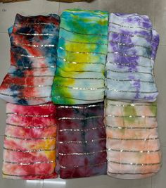 several different colors of tie - dyed material stacked on top of each other