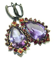 Handmade Artisan 925 Sterling Silver Earrings with natural amethyst, garnet. 18.90 grams of marvelous handcrafted jewelry design. Only ONE PIECE AVAILABLE ready to ship! Unique worldwide earrings simply piece of art in world of fine jewelry. EARRINGS DETAILS: WEIGHT: 18.90g; MATERIAL: Sterling Silver;  MAIN STONE: Amethyst;  OTHER STONES: Garnet;  DIMENSION: L -  2, W - 7/8, T - 1/4 inch;  BACKING: Latch back;  STAMP / MARK: 925;  CONDITION: New;  MAIN COLOR: purple;  SHAPE: oval;  COLLECTION: Pattaya;  ITEM CODE: 22-lis-24-17 ITEM ID: 212626 ------- SilverRush Style jewelry pieces are entirely handmade by our team with the greatest silver works and highest quality hand cut gemstones. Each piece is unique and can't be exactly duplicated, so if you see a piece that enchants you, please make Large Statement Earrings, Earrings Model, Unique Handmade Earrings, Garnet Bracelet, Buy Earrings, Emerald Pendant, Anniversary Jewelry, Back Jewelry, Silver Chain Bracelet