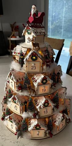 a christmas tree made out of wooden boxes with numbers on it and santa in the sleigh