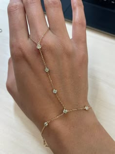 Are you looking to add a little something extra to your wrist stack? This Diamond by the inch hand harness is calling your name! Still dainty and delicate, but as your hand moves this piece will be sure to sparkle! Available in 18k Yellow Gold, Rose Gold and White Gold Total Diamond Carat Weight: .6cts Diamond Color: G Diamond Clarity: SI1 Made to order. Lead time is 2-4 weeks Benefits of 18k Solid Gold Jewelry Most loved for its durability and longevity Can be worn daily and requires less maint Hand Chain Bracelet Gold, Rose Gold And Gold Jewelry, Bracelet And Ring, Gold Hand Chain, Hand Bracelet Gold, Wrist Stack, Jewelry Inspo Gold, Cool Jewelry, Jewelry Stack