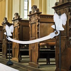 white ribbon tied to pews in an old church