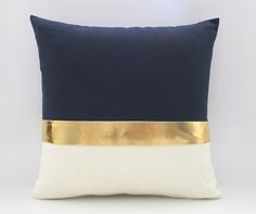 a blue and white pillow with gold trim