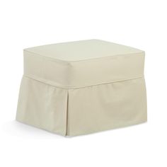 a white ottoman with a pleated skirt on it's bottom and the cover pulled down