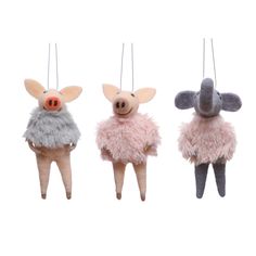 three small stuffed animals hanging from strings