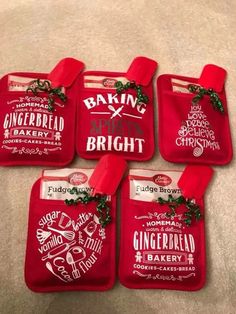 four red oven mitts with christmas decorations on them