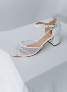 Bridal shoes 'Lily' are handcrafted from soft Italian leather with handmade embroidery on the soft mesh. They have 5.5 cm / 2.2 inches block heels that are extremely comfy.  This design also features silver floral embroidery in delicate silver thread with sequins.  Inside there is a soft Memory foam insole, which gives a feeling of additional comfort when walking. Tunit outsole is made of a mixture of leather chips and rubber, it's more wear-resistant than leather and more durable. Also, we use Embroidered High Heel Wedding Shoes, Floral Embroidered High Heel Wedding Heels, Floral Embroidered High Heels For Wedding, White Embroidered Round Toe Heels, Wedding Heels With Floral Embroidery And Round Toe, Wedding Heels With Floral Embroidery And Ankle Strap, Embroidered Low Heel Wedding Shoes, White Floral Embroidered Wedding Heels, Elegant High Heel Embroidered Sandals