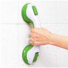 a person's hand holding a green and white shower head