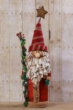 a gnome made out of old books sitting on top of a wooden table next to a star