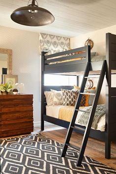 a bunk bed sitting next to a dresser in a bedroom