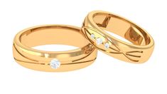 two gold wedding rings with diamonds on top and the middle one has a diamond in it