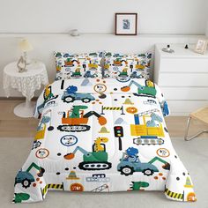 a bed with construction themed sheets and pillow cases on it in a white room next to a chair