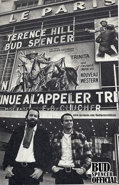 two men standing in front of a theater