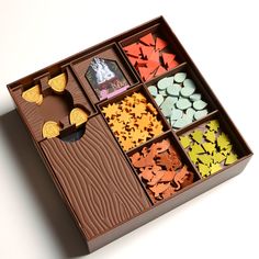 a box filled with lots of different types of candies in it's compartments