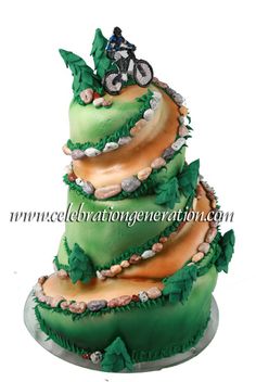 a three tiered cake decorated with green and orange icing has a bicycle on top