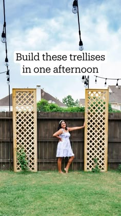 a woman standing in front of a wooden trellis with the words build these trelliss in one afternoon