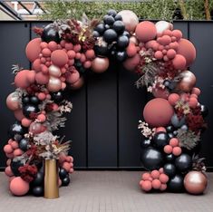 an arch made out of balloons and flowers