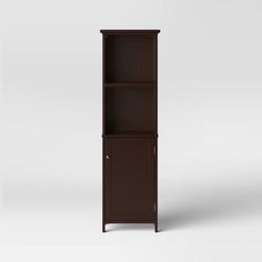 a tall brown bookcase with two shelves on one side and an open door on the other