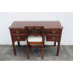 a wooden desk with two drawers and a chair