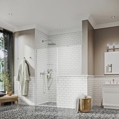 a large bathroom with white tile and black marble flooring, along with a walk in shower