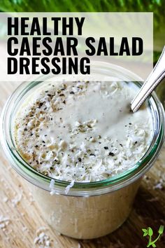 a close up of a bowl of food with the words healthy caesar salad dressing