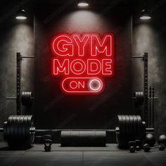 a gym room with neon sign and barbells