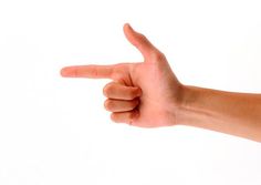 a person's hand is pointing at something on the white wall with their thumb up