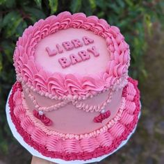 there is a pink cake that says learn baby on the top and it's frosting