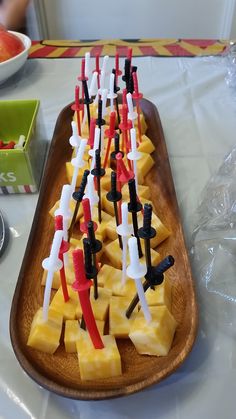 a wooden platter filled with cut up pineapples on top of a table