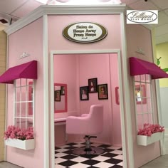 the inside of a salon with pink furniture