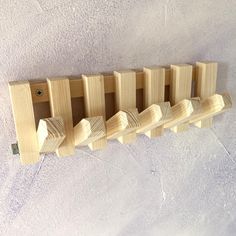 a row of wooden pegs sitting on top of a white surface