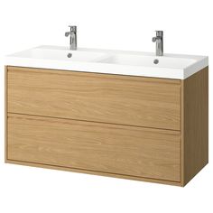 two white sinks sitting on top of a wooden cabinet