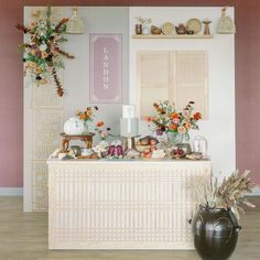 a table topped with lots of different types of food and vases filled with flowers