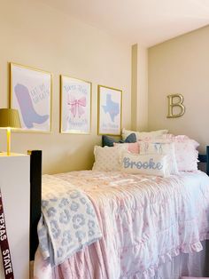 a bed room with a neatly made bed and two pictures on the wall above it