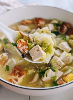 a white bowl filled with chicken and cabbage soup