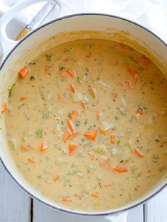 a pot filled with soup on top of a wooden table