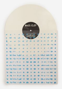 the back side of a white vinyl record with blue letters on it and a black disc that reads bass clef