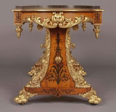 an ornately decorated wooden table with marble top