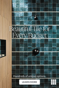 a bathroom with blue tile on the shower wall