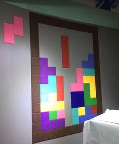 a bed sitting under a window next to a wall covered in colorful post it notes