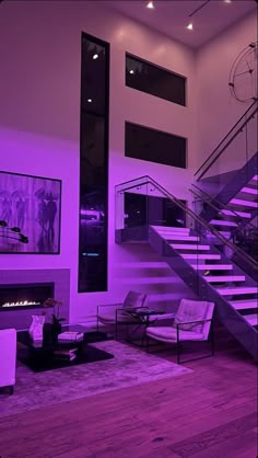 a living room filled with furniture and a fire place next to a stair case in front of a fireplace