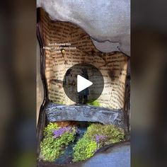 an open book with moss growing on it and a video player in the bottom right corner